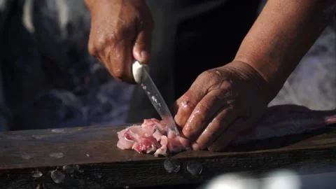 Man chops fish in boat Stock Footage 140383138