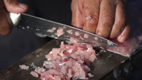 Man chops fish in boat Stock Footage 140383171