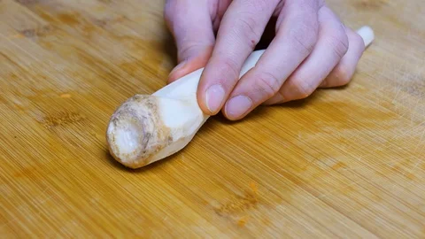 The man chops the parsley root and takes the parsley root away. Close shot. 4K Stock Footage 128595517