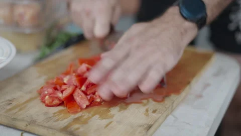 A man chops tomatoes into cubes in Valencia Stock Footage 259955808