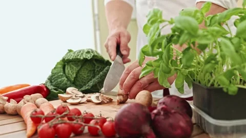 A man chops vegetables on a cutting board for a fresh dish Stock-Footage 269035386