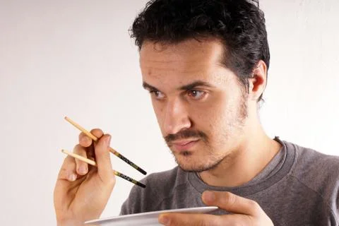 Man with chopstick Stock Photos