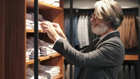 Man chossing clothes at men's wear store | Stock Video | Pond5