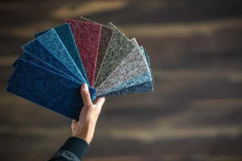 Man chossing floor from the sampler for his new apartment, household furnishing Stock Photos