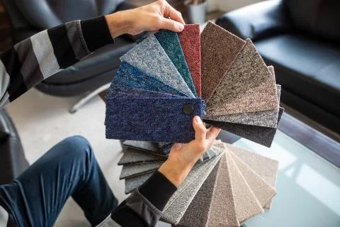 Man chossing floor from the sampler for his new apartment, household furnishing Stock Photos