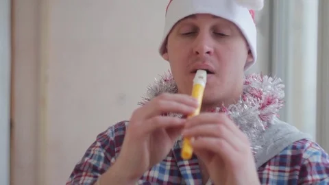 Man in Christmas cap plays the flute Vídeo Stock 70718904