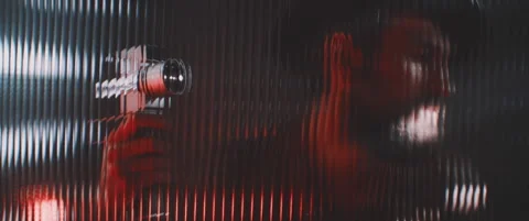 Man with cintage camera viewed thorugh a striped glass plate Stock Footage 203560662