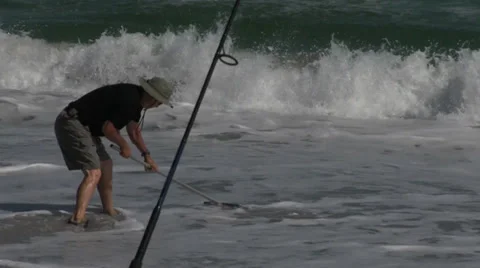 Man Clamming Runs Into Surf Stock Footage 35387581