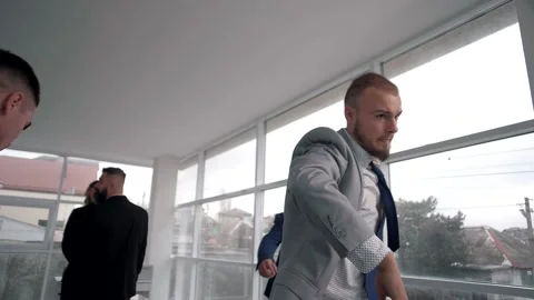 Man in classic clothes pushes his colleagues and confidently leaves the office Stock Footage 151647260