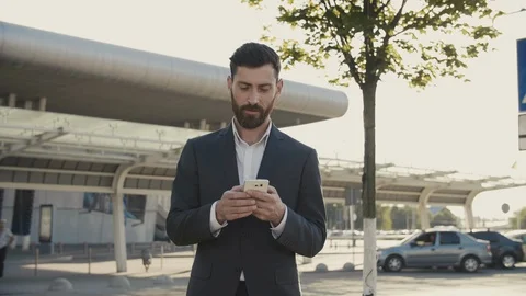 Man in Classical Suit Texting Funny Massage while Standing near Office Center Stock Footage 111075901