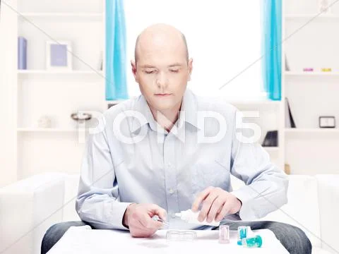 Man clean contact lenses at home Stock Photos