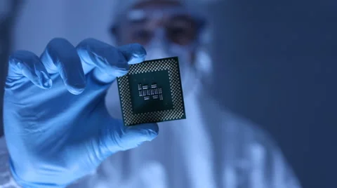 Man in clean room holds up computer cpu microchip Video stock 61667760