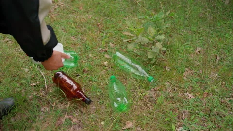 Man clean up trash in forest. Garbage dump of plastic at nature Stock Footage 158122966
