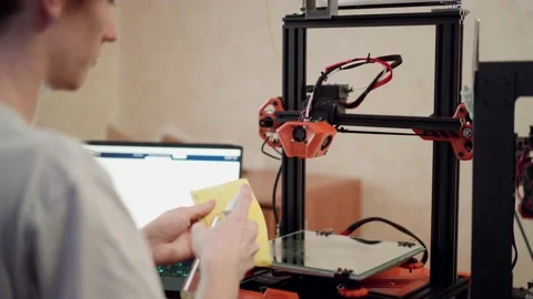 Man cleaning 3d printer before using Stock Footage 156493429