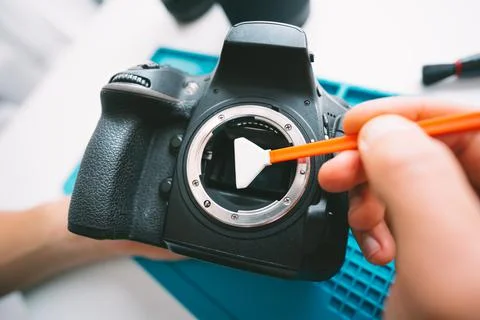 Man cleaning camera sensor with camera sensor cleaner or cleaning swab Stock Photos