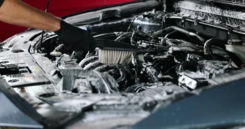 Man cleaning car engine bay with foam and brush. car wash and detailing servi Video stock 306483441