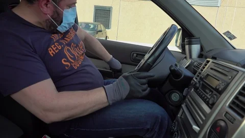 Man cleaning car interior and spraying with disinfection liquid Stock Footage 127314880