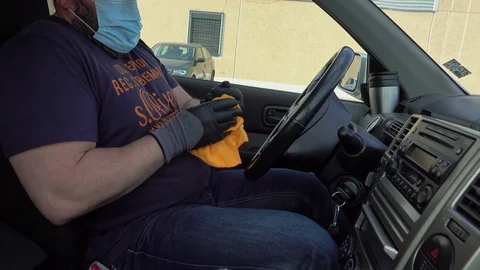Man cleaning car interior and spraying with disinfection liquid Stock Footage 127314998