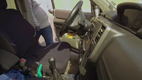Man cleaning car interior and spraying with disinfection liquid Video stock 127595754