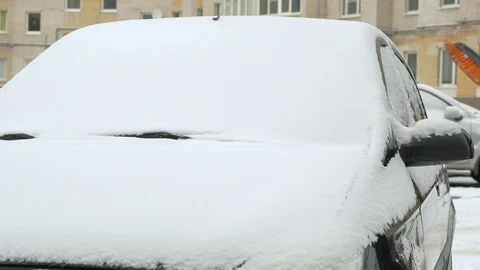 Man cleaning car from snow Stock Footage 81007660