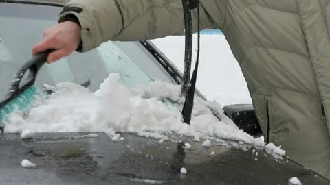 Man cleaning car from snow Stock Footage 81077363