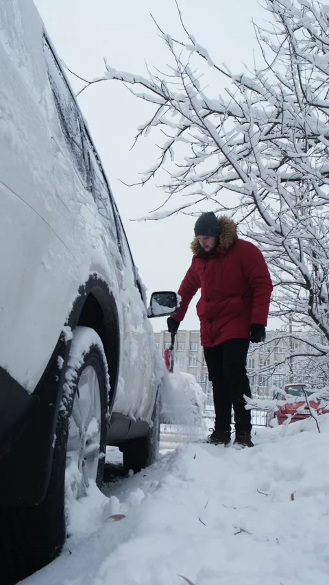 Man is cleaning car of snow Stock Footage 205589415