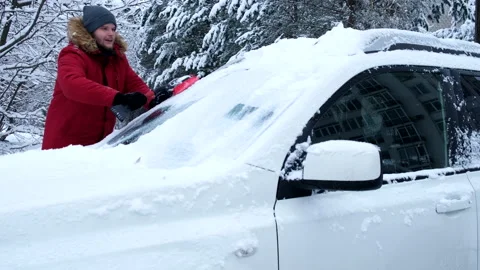 Man is cleaning car of snow Stock Footage 221853567