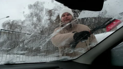 Man cleaning car of snow view from inside Video stock 227560697