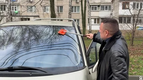 Man Cleaning Car Windshield with Brush Stock Footage 323181632