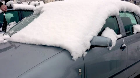 Man cleaning car windshield from snow and ice Video stock 220735975