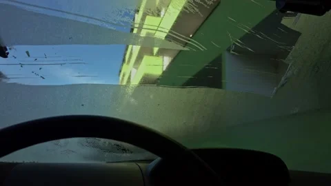 Man cleaning car windshield from snow and ice Stock Footage 231897592