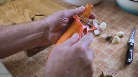 Man is cleaning carrots close-up Stock Footage 80089637
