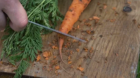 Man is cleaning carrots Stock Footage 80242182