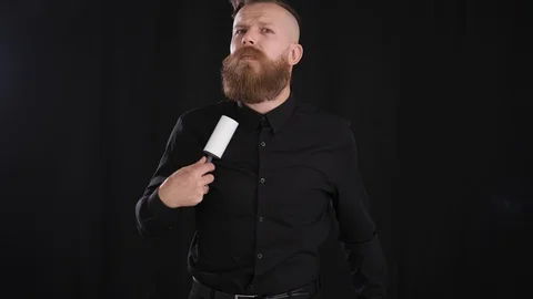 Man cleaning clothes with roller from dust and particles black Stock Footage 127626487