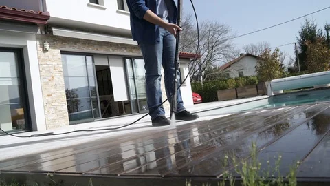 Man cleaning deck with high pressure washer Stock Footage 104189635