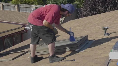 Man Cleaning Dust Off of Rooftop Skylight Window Stock Footage 212417506