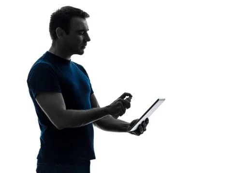 Man cleaning dusting  digital tablet  silhouette Stock Photos