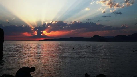 A man cleaning a fish in sunset time lapse Stock Footage 81279643