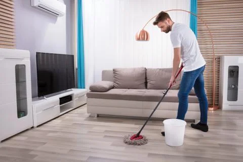 Man Cleaning Floor With Mop Stock Photos