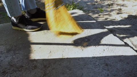 Man Cleaning the Floor outside on Yard Stock Footage 96196873
