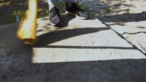 Man Cleaning the Floor outside on Yard Stock Footage 96196929