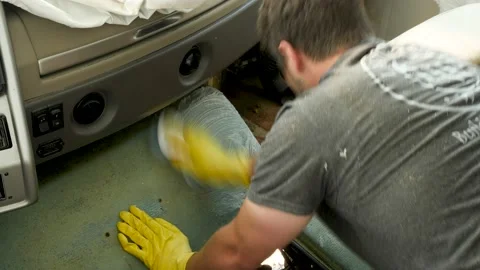 Man cleaning the front interior of an RV while wearing gloves Stock Footage 148122273