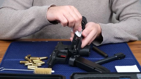 Man cleaning gun Stock Footage 261136024