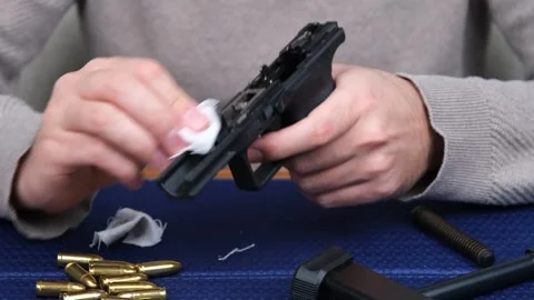 Man cleaning gun Video stock 264092638