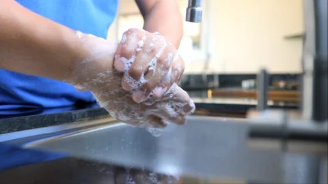 Man cleaning hand and have water flowing at the sink in cooking room, Covid-19 Stock Footage