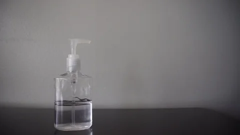 Man Cleaning Hands Using Antibacterial Alcohol Sanitizer Stock Footage 128010511