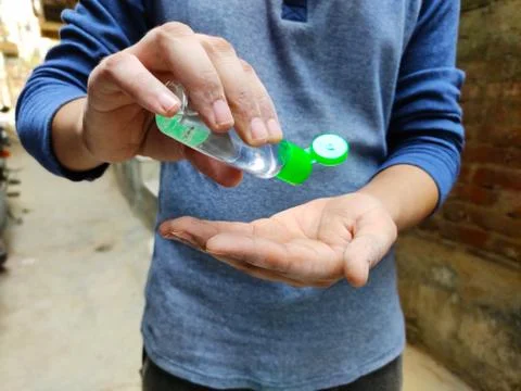 Man cleaning hands using Sanitizer  Stock Photos