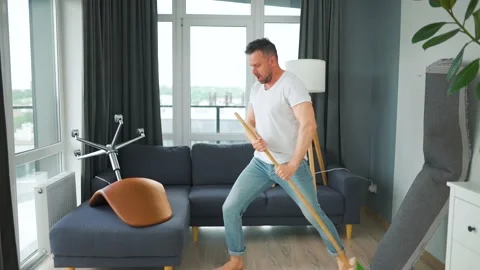 Man cleaning the house and having fun dancing with a broom. Stock Footage 210876102