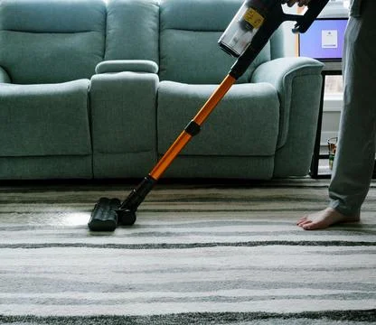 Man Cleaning House While Working From Home Stock Photos