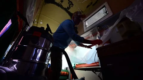 Man cleaning the interior of a camper van with a vacuum cleaner Stock-Footage 347637034